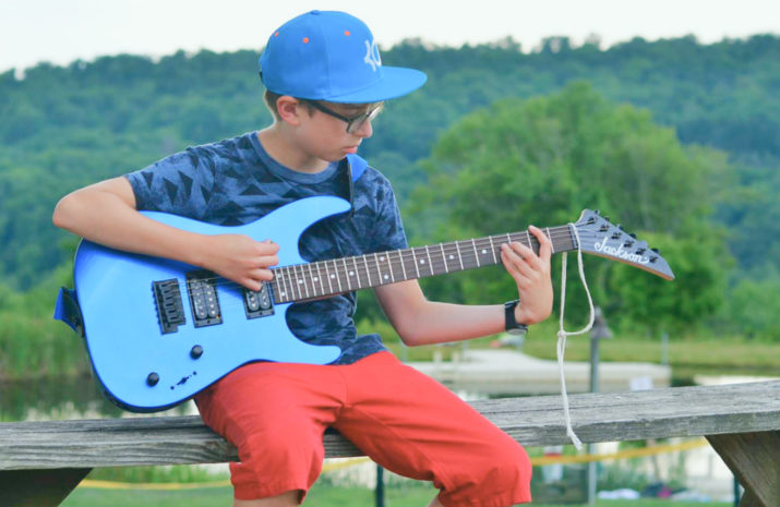 Camper playing the electric guitar