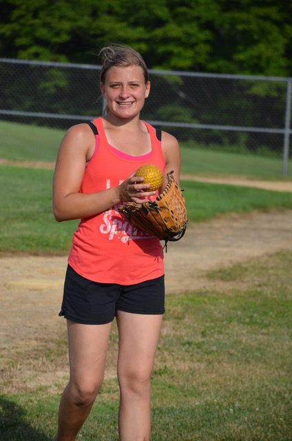 girl smiling after catching softball