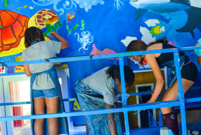 Campers painting a mural