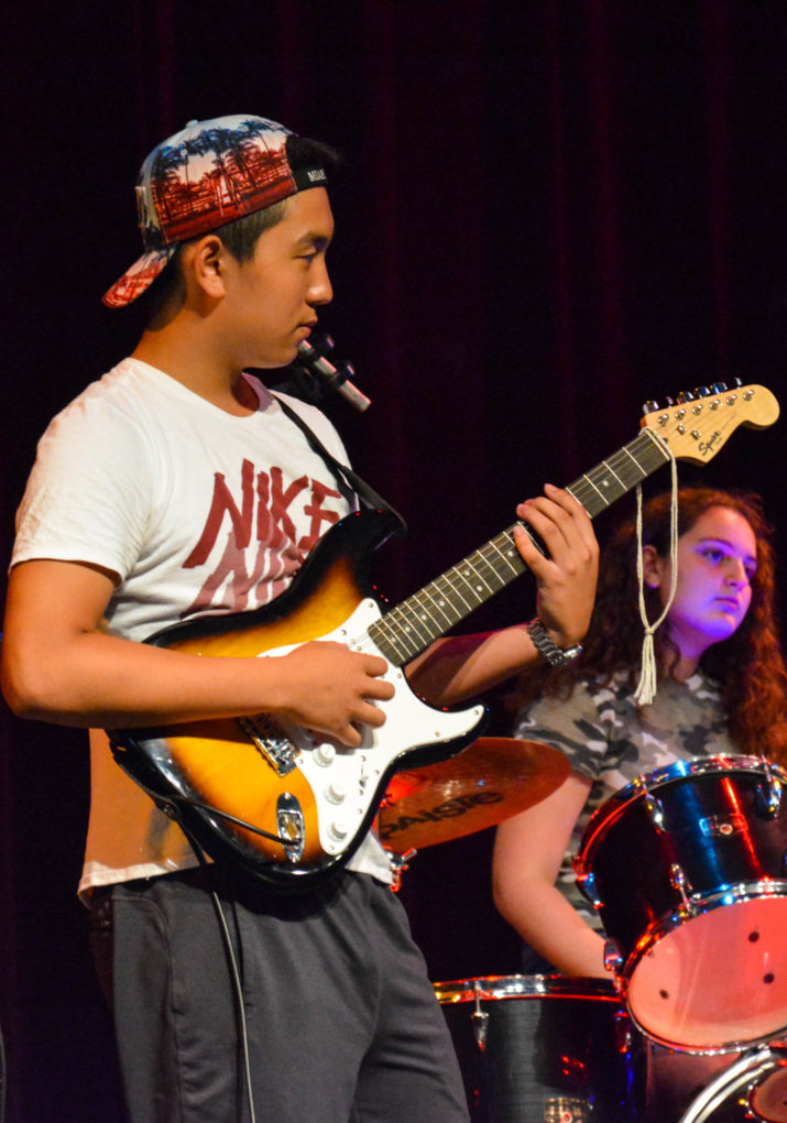 Campers playing in a band on stage