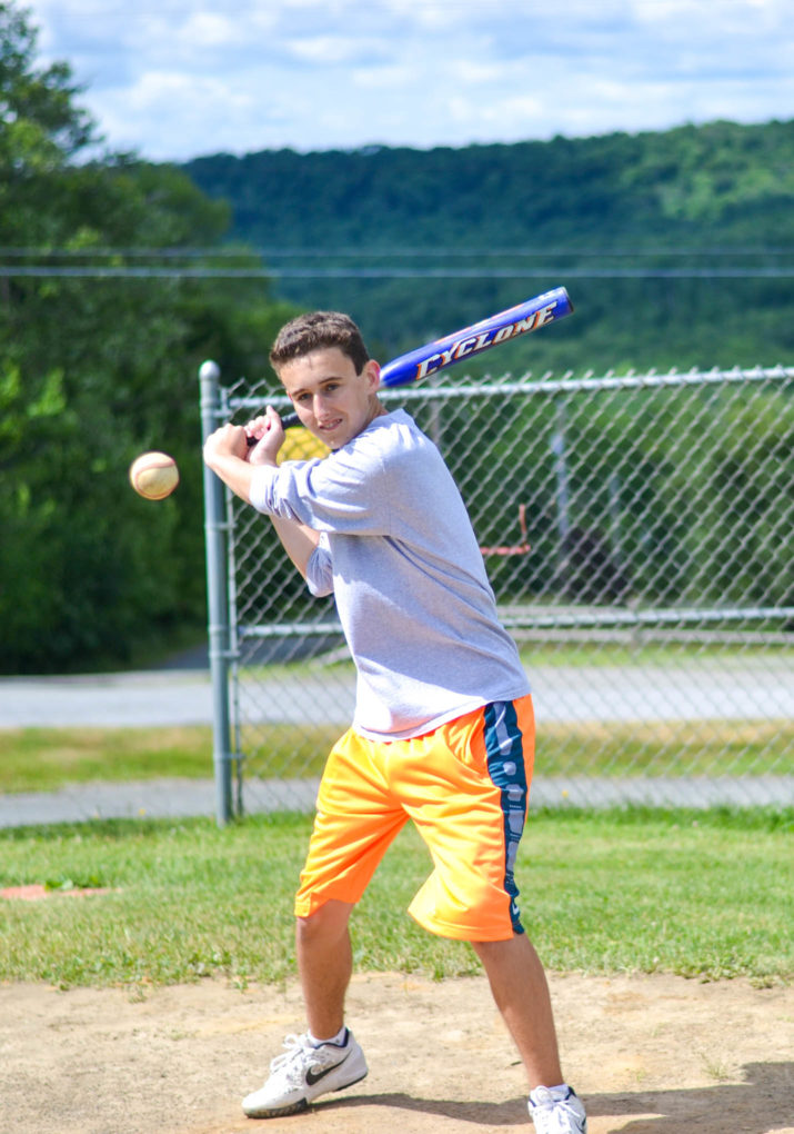 Camper getting ready to hit a ball with a baseball bat