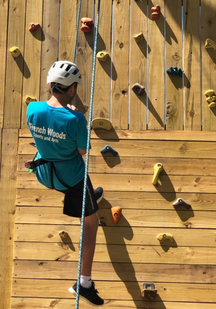 Camper climbing the rock wall