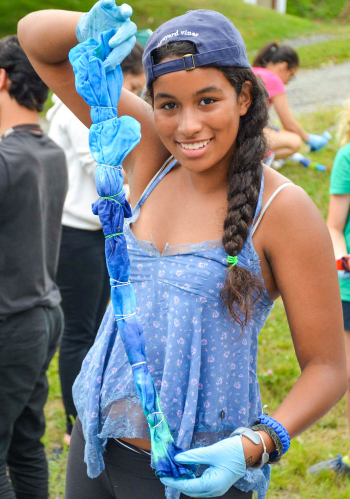 Camper holding up a shirt she is tie dying