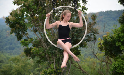 Camper sitting on a hanging hoop