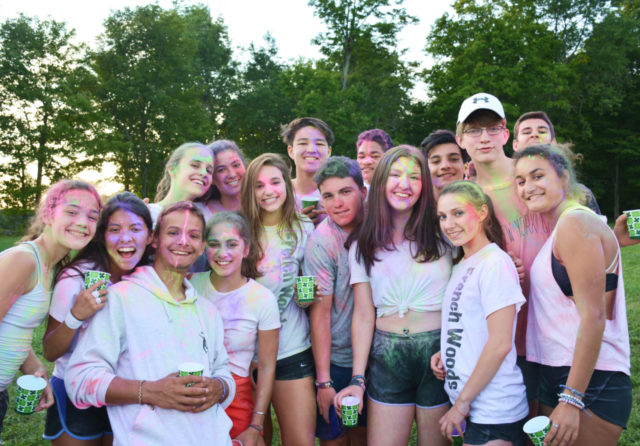 Group photo of campers covered in colorful chalk