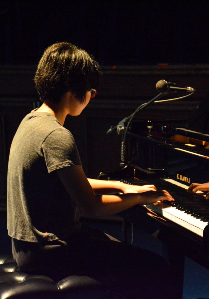 Girl camper playing the piano on stage