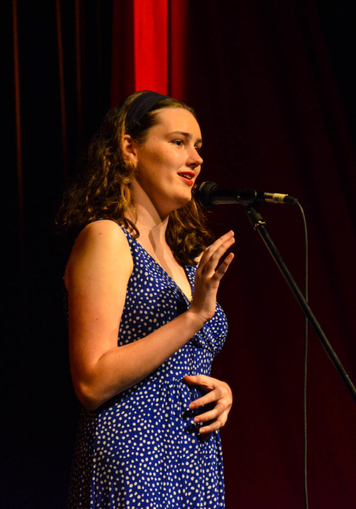 Girl camper singing on stage