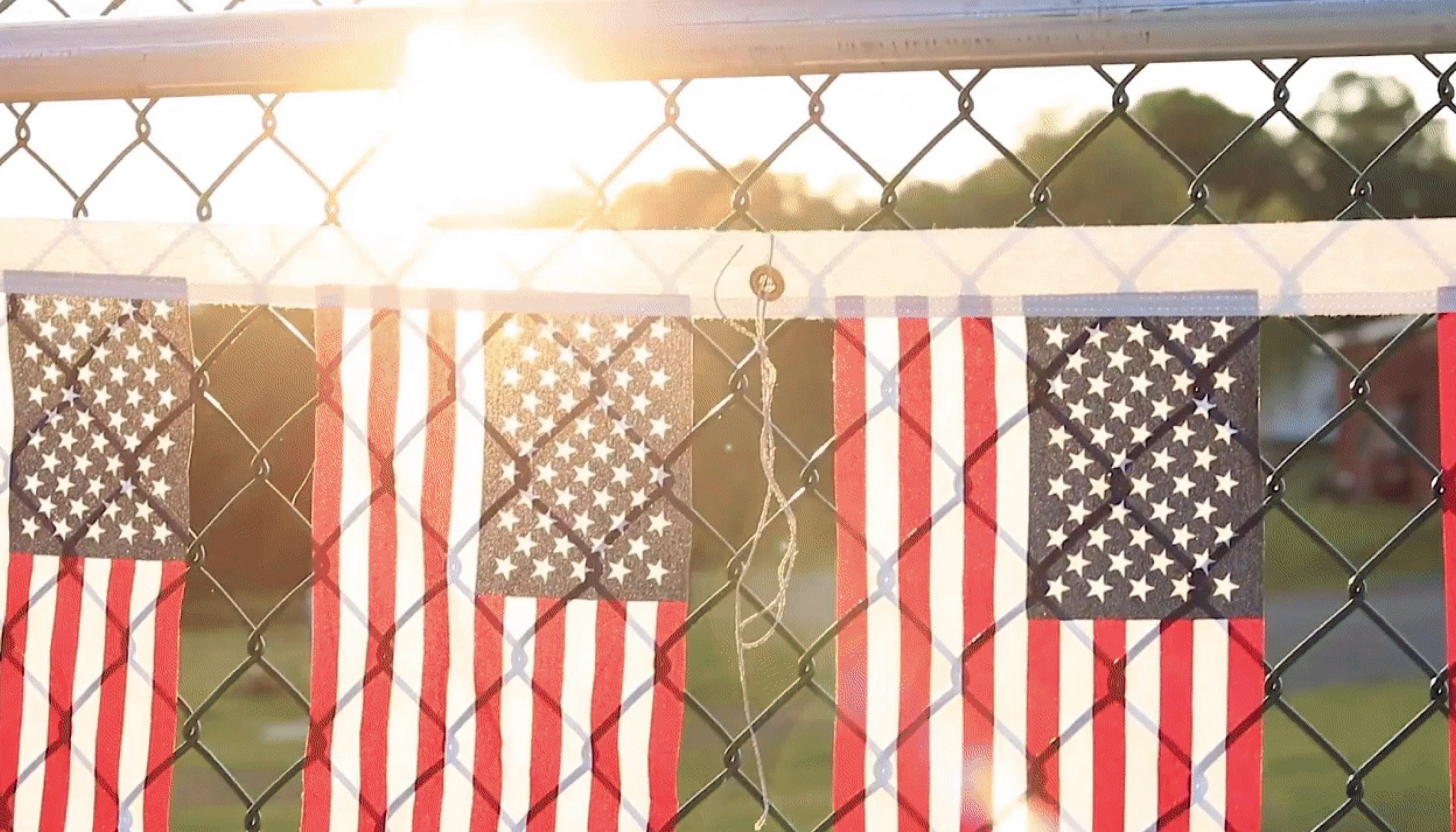 American flags hanging on a fence