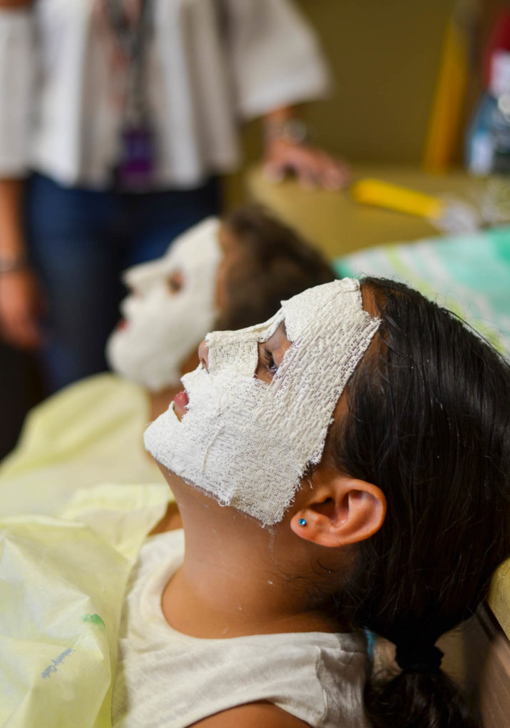 Campers molding their faces for masks