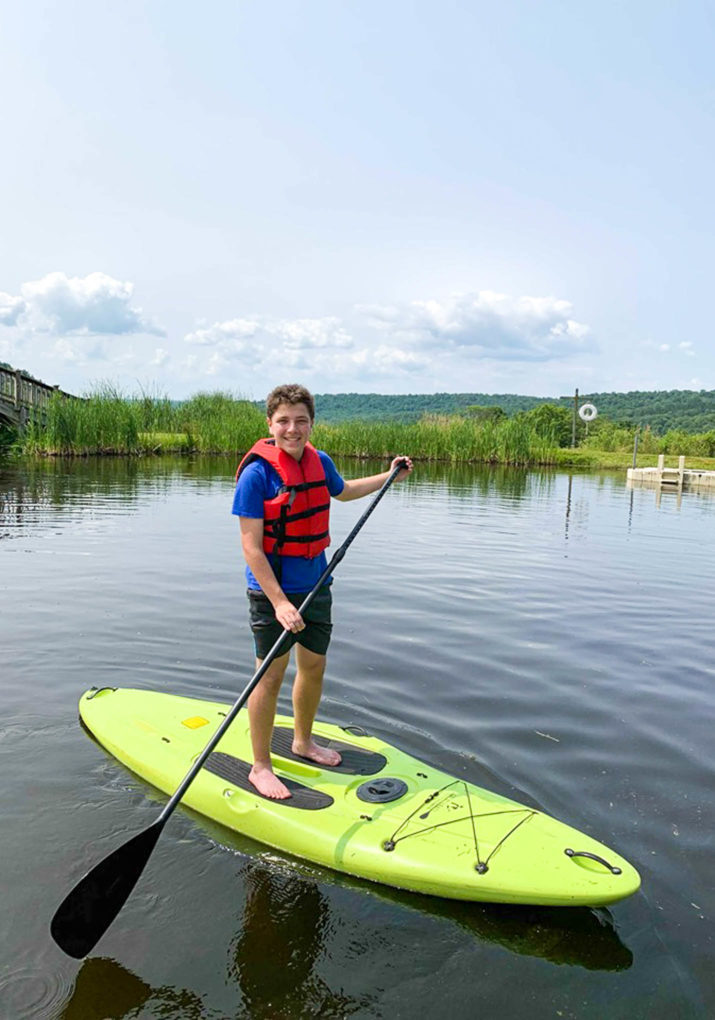 Camper on a stand up paddle board