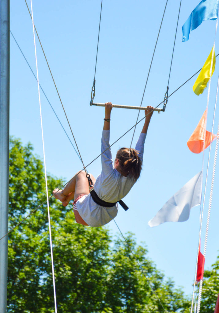 Camper swinging on a trapeze swing