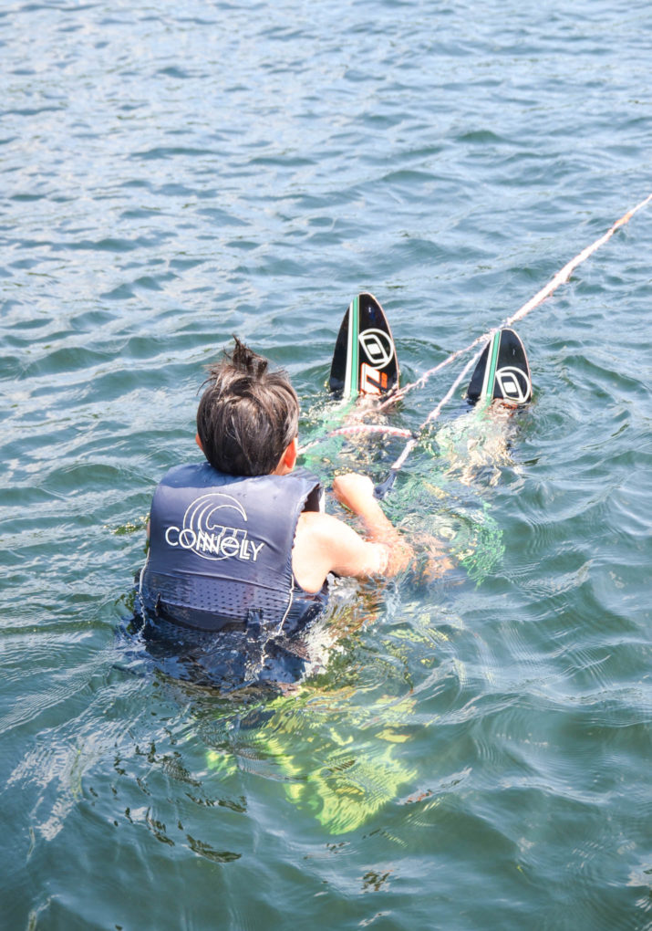 Camper waiting in the water with waterskis