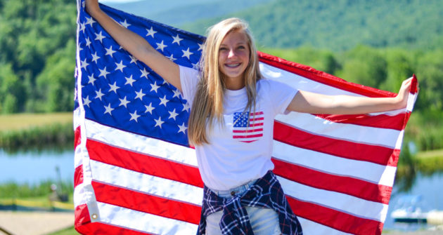 Camper holding up an American Flag