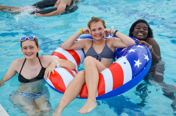 Campers hanging out in the pool