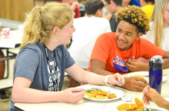 Campers chatting at meal time