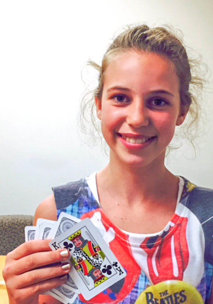 Girl holding up playing cards