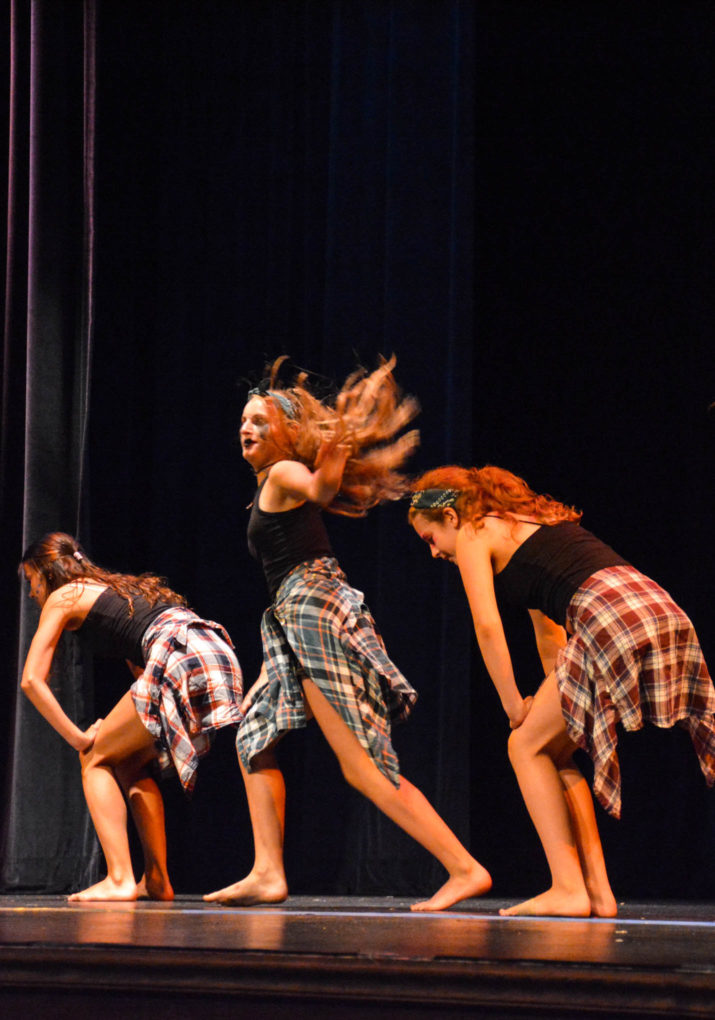 Three campers dancing on stage