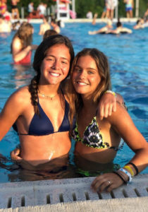 Two girls smiling in the pool together