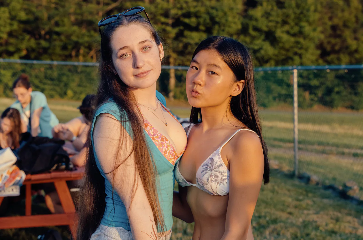 Two teen campers posing together beside the pool at New York Teen Camp